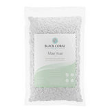 A clear plastic bag filled with white wax beads from Black Coral Wax Canada, labeled Mae Mae Hard Wax