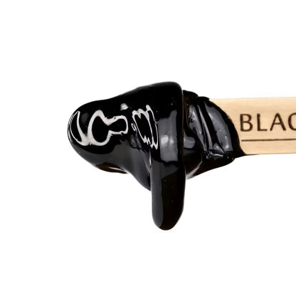 black coral hard wax in wooden spatula