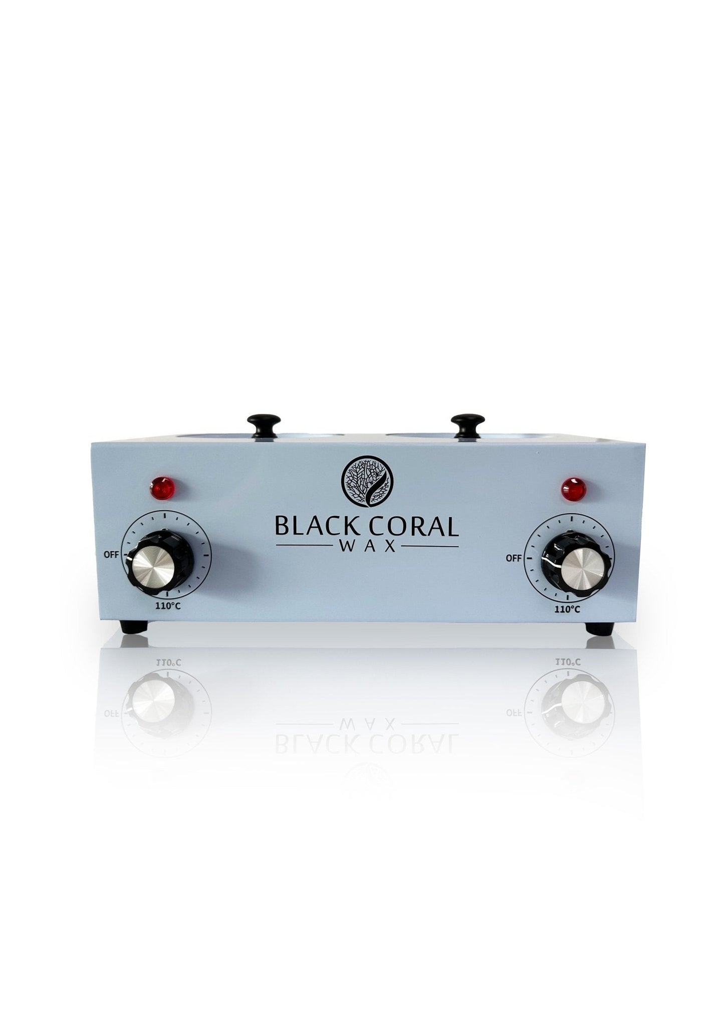 The Black Coral Wax USA Double (2x1lb) Wax Warmer is a rectangular unit with dual temperature control knobs, red indicator lights, and the brand logo on front, shown on a white reflective surface.