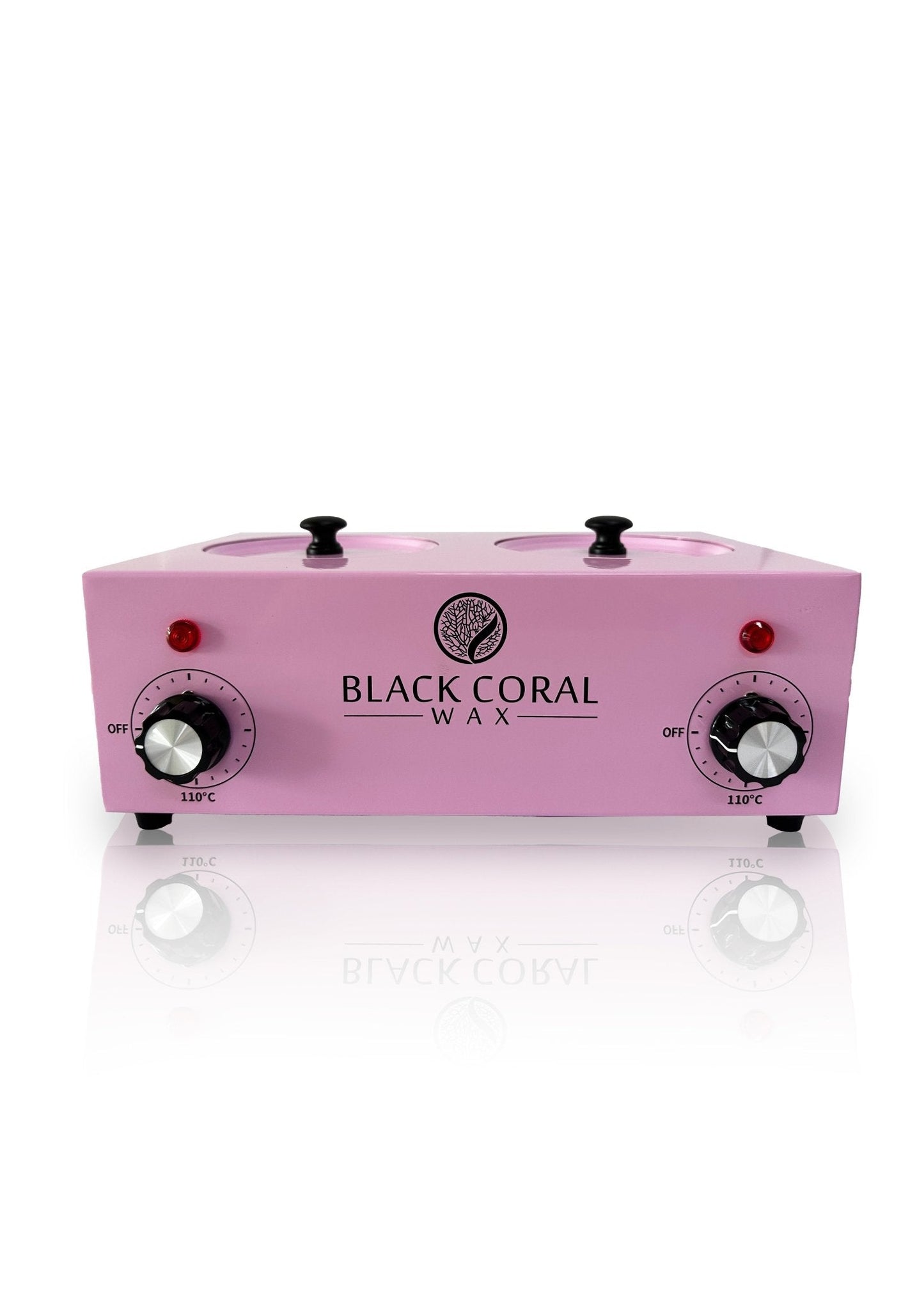 The Black Coral Wax USA Double (2x1lb) Wax Warmer is pink with two pots, silicone inserts, temperature control dials, power switches, and indicator lights on the front panel. The brand logo appears in black between the controls.